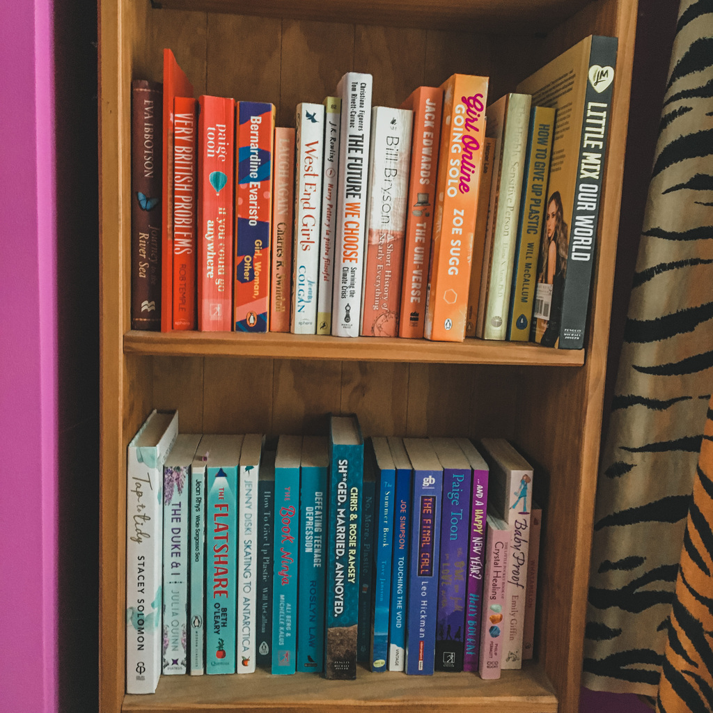 bookshelf with books in rainbow order