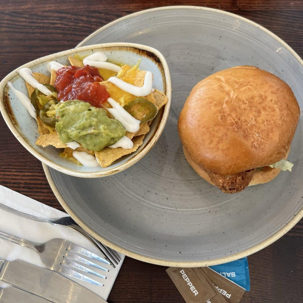 Slug and Lettuce Bournemouth: Plant-based burger with vegan nachos on a blue plate